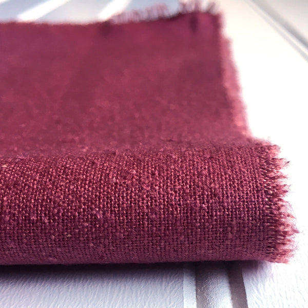 close-up of folded mauve raspberry raw silk noil